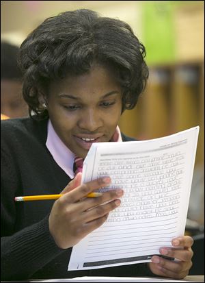Chase eighth-grader Cylenthia Pickett looks over her work. Cylenthia was kicked out of school and arrested for fighting last year. She knew she did wrong. ‘I thought I was big and bad.’