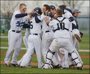 Lake’s Aaron Witt (5) is mobbed by teammates after his groundout to second base led to the winning run.