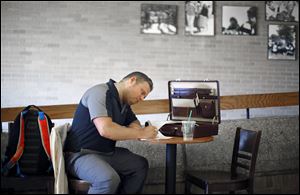 Josh Howarth, University of Toledo senior, studies in the coffee shop in the student union. Economists at the Federal Reserve Bank of New York say that unemployment and underemployment of recent graduates are higher than historical norms.