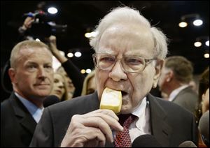 Berkshire Hathaway Chairman and CEO Warren Buffett eats an ice cream bar while touring the exhibition floor prior to the annual shareholders meeting today in Omaha, Neb.
