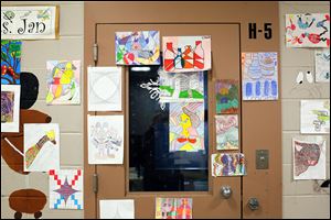 A door and surrounding walls on H Block in the Lucas County Juvenile Detention Center are covered with the art created by student inmates.