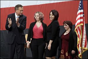 Ohio Gov. John Kasich, from left, introducing Amanda Berry, Gina DeJesus and Michelle Knight during his State of the State address in February at the Performing Arts Center in Medina, Ohio.