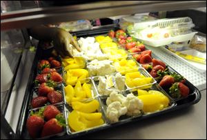 Fruit and vegetables are served during lunch service at the Patrick Henry Elementary School in Alexandria, Va.