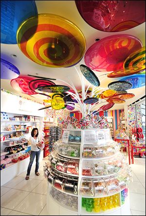 Debbie Troyan of Cleveland visits the new Dylan's Candy Bar in the Concourse A in McNamara Terminal at Detroit Metro. The airport is blending national chains with local options and adding technology that will allow passengers to get food at some gates. Officials say the project should be completed by the end of 2015.