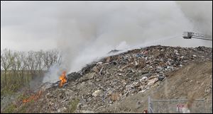 A file photo of Toledo firefighters working on a fire at a Stickney Recycling debris pile in Toledo.
