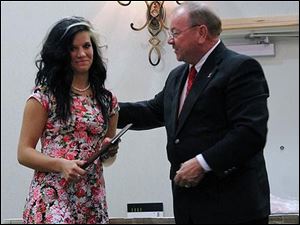 Jessica Grindle accepts her Owens Female Athlete of the Year award from Owens President Mike Bower at a banquet this week.