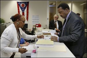 Election worker June Boyd helps Jack Ford file his petitions today at the Lucas County Board of Elections in Toledo. The independent candidate is running for State Senate District 11.