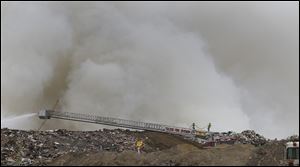 Toledo firefighters work on fire at a Stickney Recycling debris pile in Toledo.