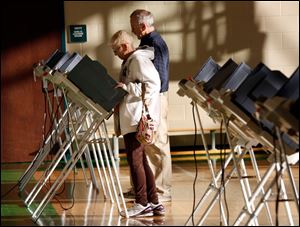 Sue and John Fitzgerald cast their ballots on primary election day, at the polling place inside Beverly Elementary School in South Toledo.