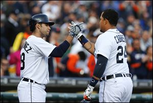 Detroit Tigers' Miguel Cabrera (24) celebrates his solo-home run with teammate J.D. Martinez against the Houston Astros during the first inning.
