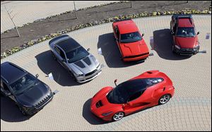 A LaFerrari is displayed alongside Fiat and Chrysler vehicles  in Auburn Hills, Mich. Fiat owns the Ferrari brand. Fiat Chrysler Automobiles’  plan includes investing big in re-establishing Alfa-Romeo.