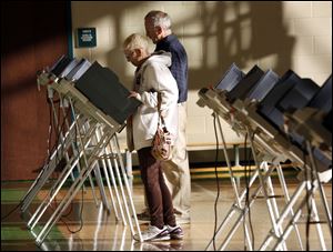 Sue and John Fitzgerald cast their ballots today at the polling place inside Beverly Elementary School.
