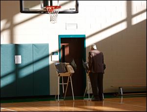 Richard Brownlee casts his ballot on primary election day, Tuesday, May 6, 2014, at the polling place inside Beverly Elementary School in South Toledo.