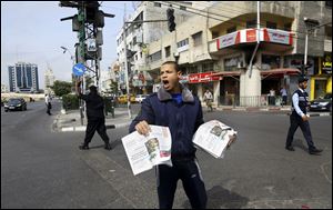 A Palestinian vendor shouts as he sells Al-Quds newspaper on the first day of its arrival to Gaza from the West bank since being banned by Hamas in 2008, in Gaza City, the northern Gaza Strip, today.