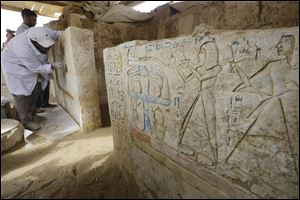 An Egyptian conservator cleans limestones at a newly-discovered tomb dating back to around 1100 B.C. at the Saqqara archaeological site, 19 miles south of Cairo, Egypt, today.
