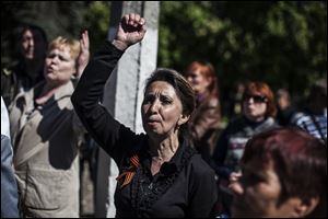 A pro-Russia Ukrainian woman chants slogans against the Kiev government after a funeral service for several pro-Russia gunmen and a civilian in Slovyansk, Ukraine, Wednesday.