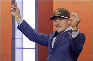 Texas A&M quarterback Johnny Manziel reacts after being selected by the Cleveland Browns as the 22nd pick in the first round of the 2014 NFL Draft, Thursday in New York.