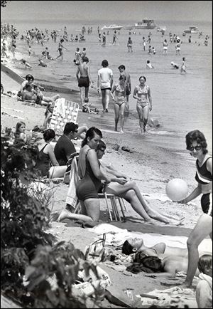 Swimmers and sunbathers enjoy the East Harbor beach four months before a storm destroyed it in 1972.