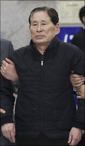 Kim Han-sik, president of Chonghaejin, is escorted by helpers to hold a press conference at Incheon Port International Passenger Terminal in Incheon, South Korea. 