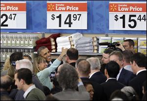 President Barack Obama poses for a selfie photo after speaking today at a Walmart store in Mountain View, Calif.