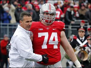 Jack Mewhort is greeted by head coach Urban Meyer during senior day.