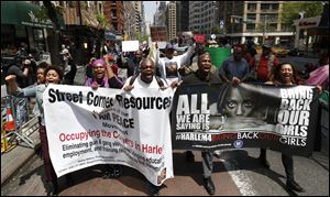Demonstrators arrive in front of the Nigerian consulate after marching from Harlem during a rally today in New York. 