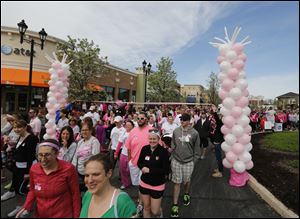 Thousands of people begin the walk to fund breast cancer research and services. 