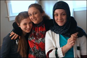 Mother's Day Ayla Eldek, center, is embraced by her daughters Meliha, 16, left, and Gulsu, 13, at their home in North Toledo. Originally from Turkey, the family says they celebrate Mother's Day with gestures of love and small gifts. 