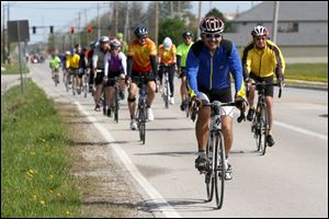 John Gray of Oregon leads bicyclists making their way down Fort Meigs Road during Saturday’s safety workshop in Perrysburg. The event was for participants in the upcoming Bike to the Bay fundraiser.