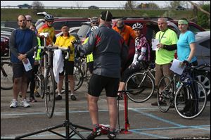 Toledo Area Bicyclists member Brian Gribble, center, leads a workshop Saturday at Fort Meigs YMCA in Perrysburg. The clinic included a primer on the rules of the road, safety tips and general cycling etiquette.