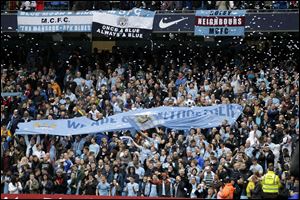 Manchester City fans hold up a banner before the English Premier League soccer match between Manchester City and West Ham today at the Etihad Stadium in Manchester, England.