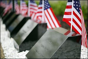 Flags adorn the memorial stones during the memorial ceremony.