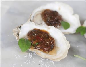 Grilled Oysters with Miso Black Beans and Chili Garlic.