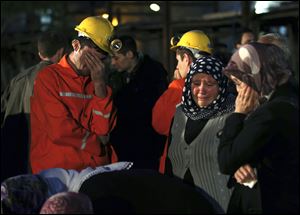 Miners and family members wait outside a coal mine in Soma, western Turkey, early today.