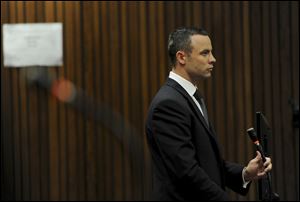 Oscar Pistorius stands in the dock at the high court in Pretoria, South Africa, today. The judge overseeing the murder trial of Pistorius on Wednesday ordered the double-amputee athlete to undergo psychiatric tests, meaning that the trial proceedings will be delayed. 