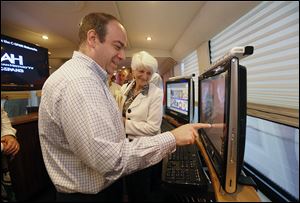 Keith Meyer, left, does a quiz while fellow Kiwanian Pat Lora watches  during a tour of the  C-SPAN bus.