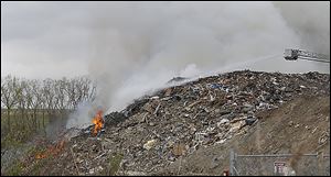 Toledo firefighters work earlier this month to extinguish the fire that broke out at Stickney Recycling, a construction and demolition debris landfill in North Toledo.