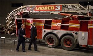 President Obama and former New York City Mayor Michael Bloomberg tour the destroyed Ladder 3 truck at the September 11 Memorial Museum.