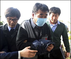 Lee Joon-seok, center, the captain of the sunken ferry boat Sewol in the water off the southern coast, arrives at the headquarters of a joint investigation team of prosecutors and police in Mokpo, south of Seoul, South Korea last month.