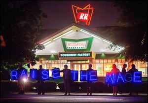 Fast-food workers and supporters protest low wages outside a Krispy Kreme store in Atlanta. Calling for higher pay and the right to form a union without retaliation, workers protested Thursday as part of a wave of strikes and protests in 150 cities nationwide and 33 countries on six continents.