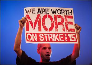 Antwon Brown, 31, joins other fast-food workers and supporters in a protest in Atlanta. Organizers say the workers’ action forced many restaurants to close  for a short time on Thursday.