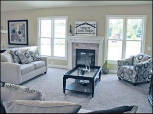 This comfortable great room includes a Craftsman-style fireplace.