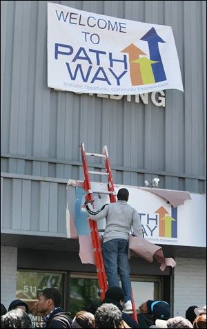 Jerradis Bradford removes the cover to the new sign.