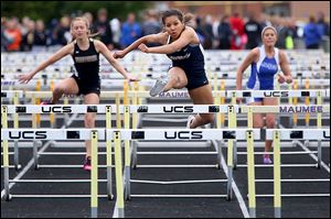 Napoleon’s Peyton Lee, center, pulls ahead in the 100-meter hurdles at the NLL championships. Lee won with a time of 15.48 seconds.