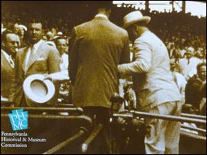 A still from the video of FDR at the 1937 All-Star Game at Griffith Park in Washington shows the polio-stricken 32nd president being helped from the field to his seat. 