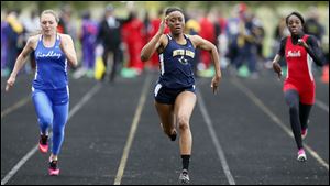 Chanatlia Young of Notre Dame, center, wins the 100 meter dash during the TRAC meet.