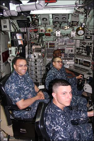USS Toledo crew members, from front, Seaman Michael Delloiacono and Petty Officers Tyler White, Jorge Hernandezpolo, and Montez Curry are in the sub’s control room while docked at the U.S. Naval Submarine Base New London in Groton, Conn.