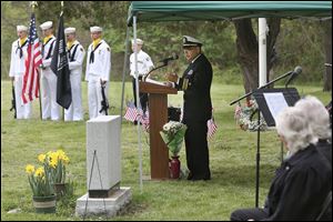 Lt. Cmdr. Vidal Valentin addresses guests during the Veteran’s Memorial program on Saturday in the former Toledo State Hospital Cemetery behind Bowsher High School.