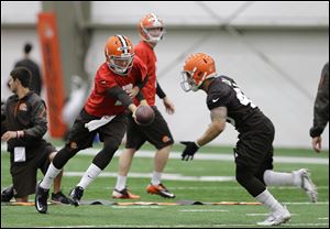 Cleveland Browns quarterback Johnny Manziel hands off during a rookie minicamp practice today at the NFL football team's facility in Berea.