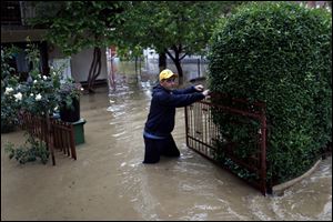 Rain-swollen rivers across the Balkans have flooded roads, cut off power and caused more than 200 landslides.